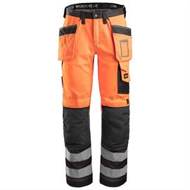 Kõrge visiiriga tööpüksid, mille taskud on kõrgvisiirilised klassi 2 oranžid.